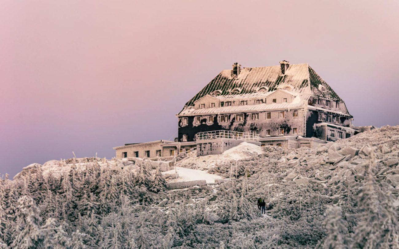 A snowy, frozen building in the winter landscape of Szklarska Poręba, Poland.