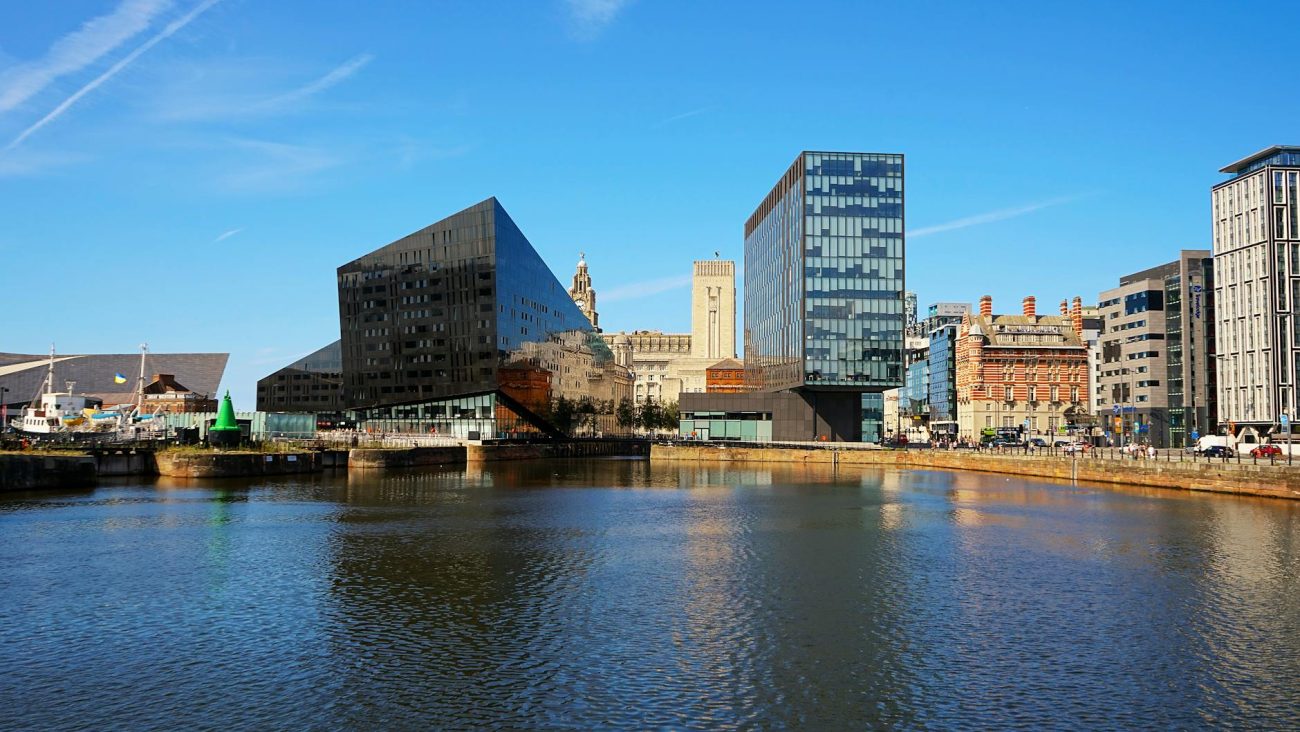 Stunning view of modern architecture along Liverpool's waterfront showcasing iconic buildings and reflection.