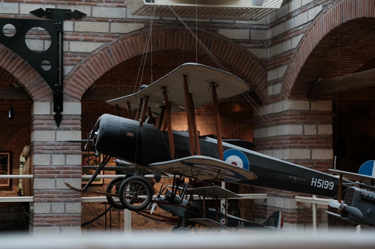 Vintage aircraft suspended in a museum, showcasing classic aviation history.