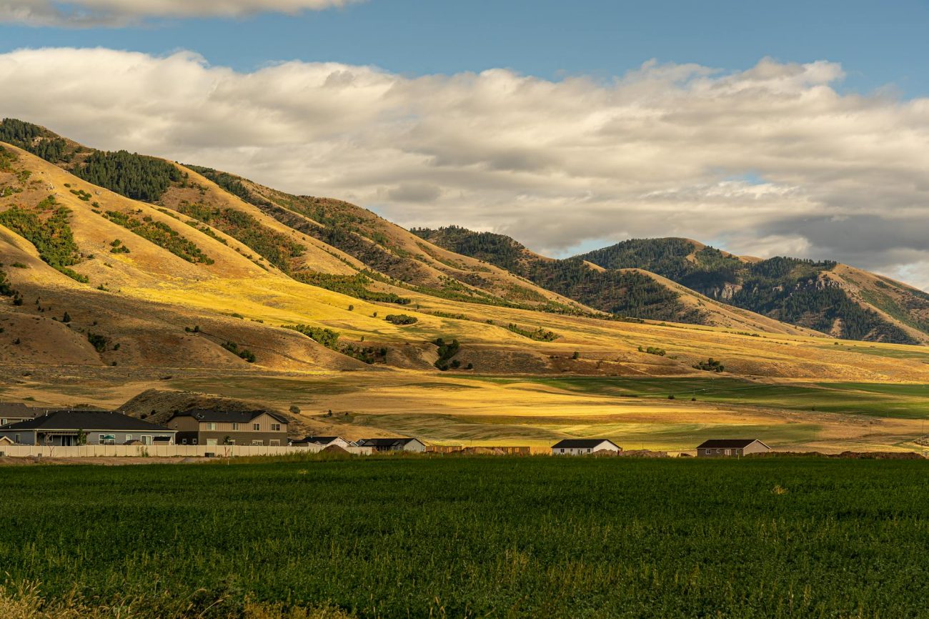 Scenic view of rolling hills and fields near Hyrum, Utah showcasing countryside charm.
